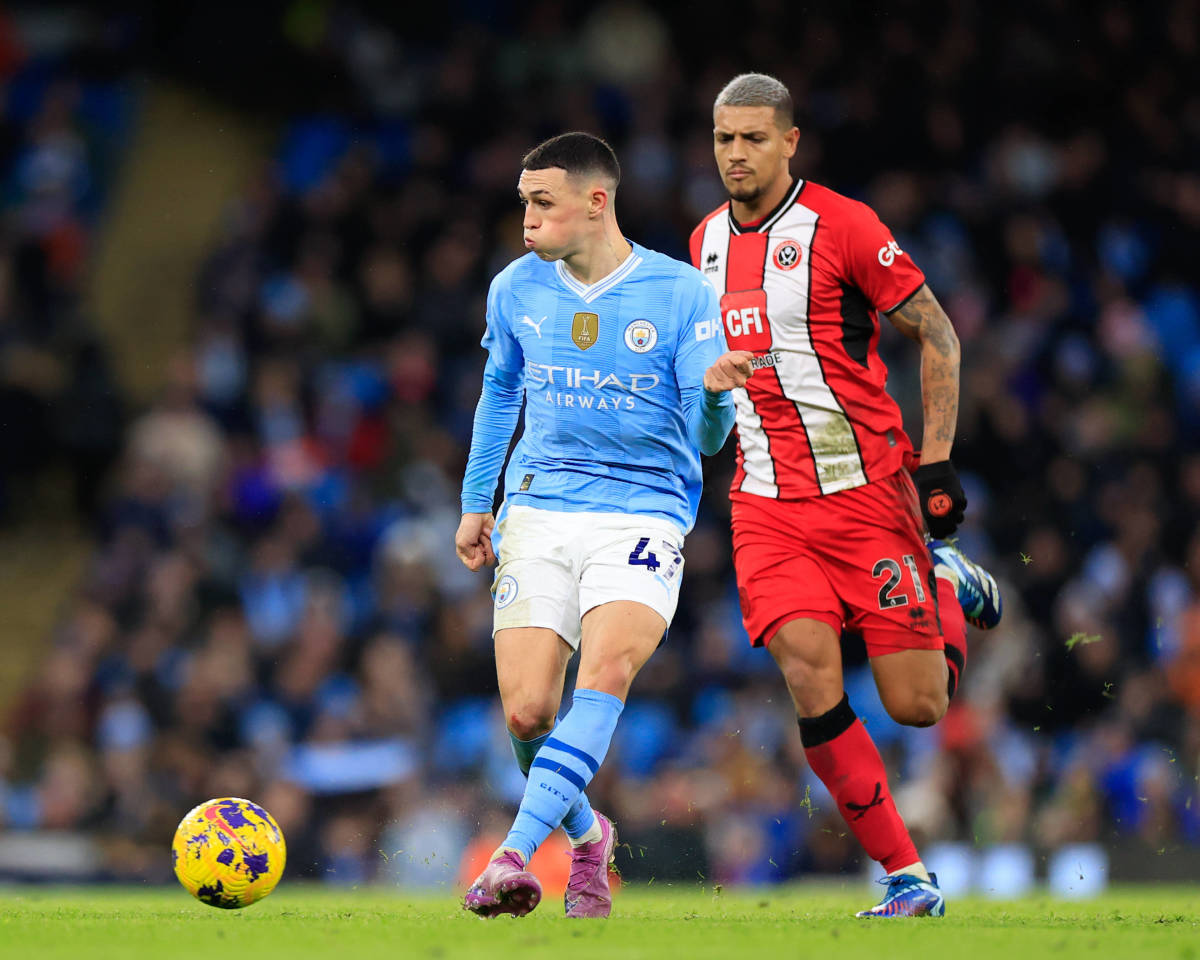 Phil Foden pictured (center) passing the ball during Manchester City's 2-0 win over Sheffield United in December 2023